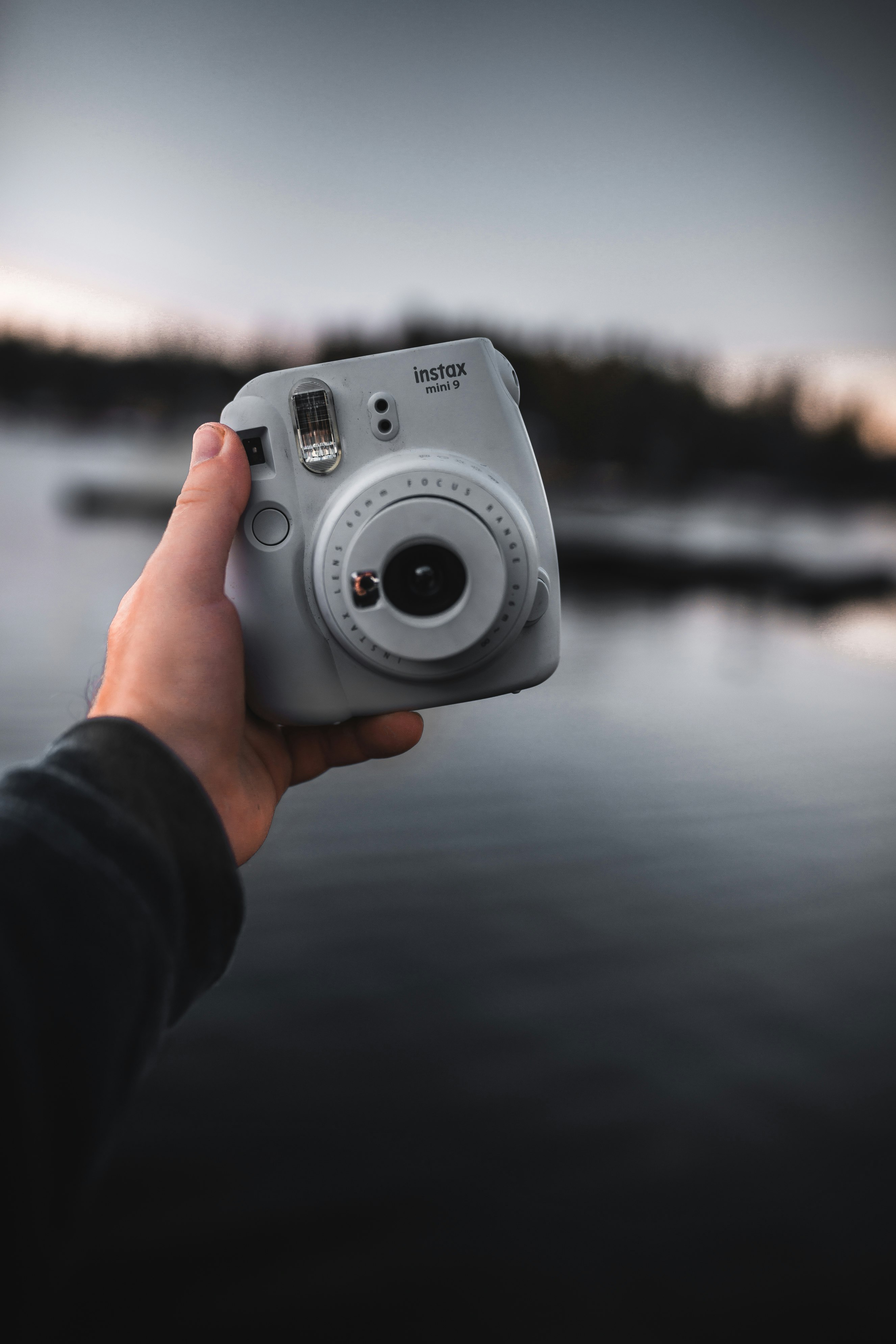 person holding gray and black camera